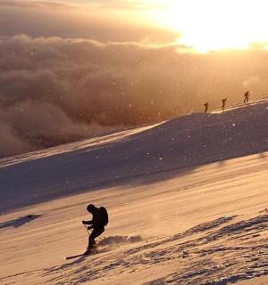 a man is skiing down a snow covered slope