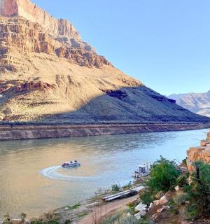 a boat on a river in a canyon