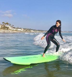 a woman riding a wave on a surfboard in the ocean