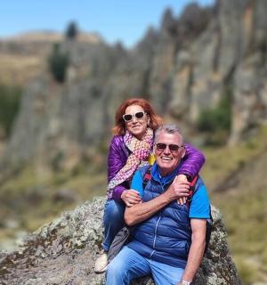 a man and a woman sitting on a rock