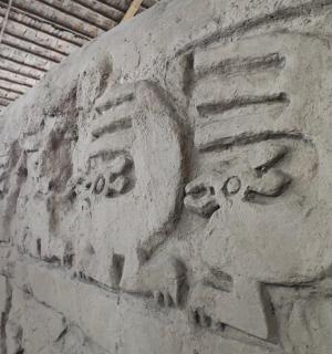 a stone wall with a face painted on it