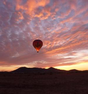 a hot air balloon in the sky at sunset
