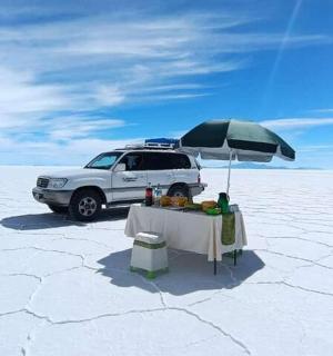a table with an umbrella in the middle of a desert