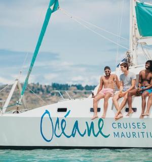 a group of people sitting on a boat in the water