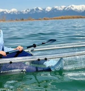 a woman sitting in a boat on the water