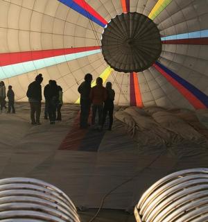 a group of people standing inside of a hot air balloon