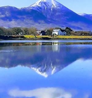 a large body of water with a mountain in the background