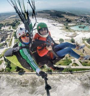 two people are sitting on a parachute