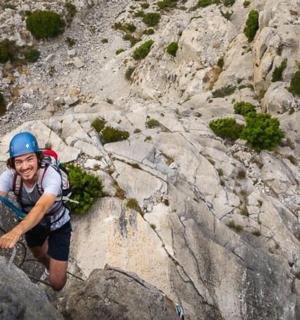 a man is climbing on a rocky mountain