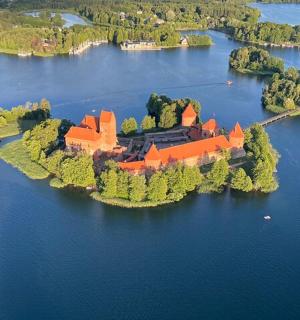 an island in the middle of a lake with a mansion