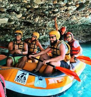 a group of people in a raft in the water