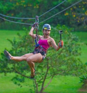 a woman is riding on a zip line