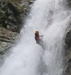 a person standing in front of a waterfall