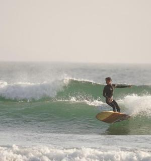 two people riding a wave on surfboards in the ocean