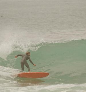 a man riding a wave on a surfboard in the ocean