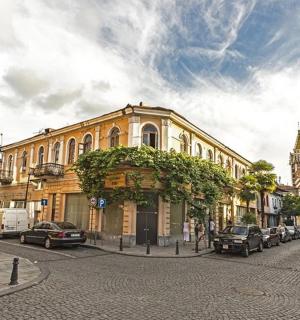 a city street with cars parked in front of a building