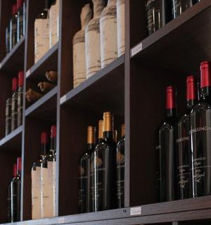 a bunch of wine bottles on shelves in a store