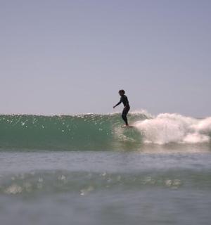 a person riding a wave on a surfboard in the ocean