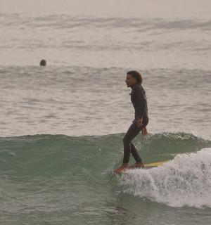 a person riding a wave on a surfboard in the ocean