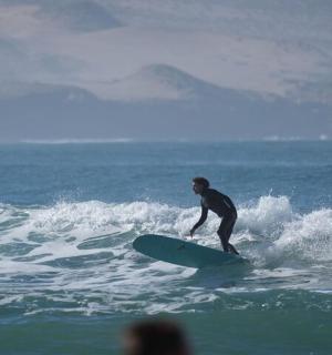 a man riding a wave on a surfboard in the ocean