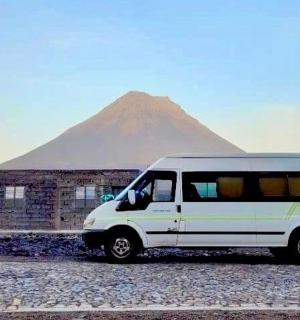 a white van parked in front of a mountain