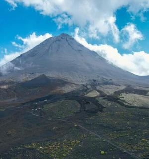 an aerial view of a mountain in the sky