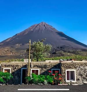 a mountain in the distance with a building in front