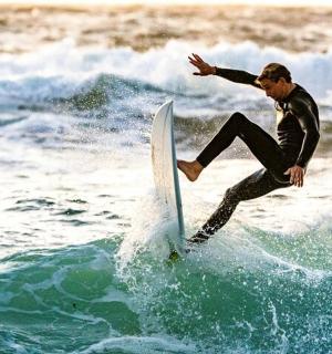 a man riding a wave on a surfboard in the ocean
