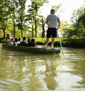 a man is standing on a boat in the water