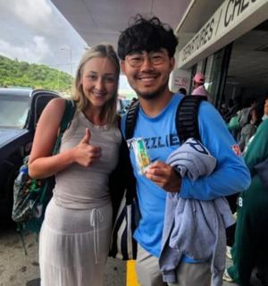 a man and a woman standing at a bus stop