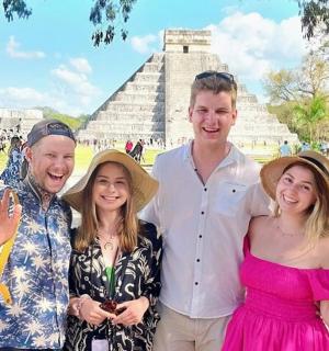 a group of people standing in front of a pyramid