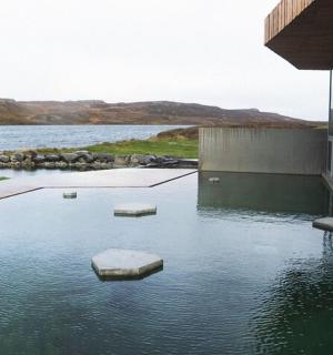 vodní plocha vedle budovy s kameny v ní