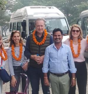 a group of people standing in front of a bus