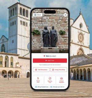 a phone in front of a building with a statue