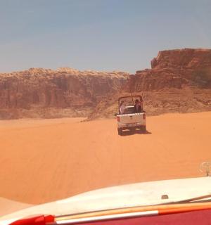 a jeep driving through the desert