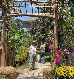 a man and a woman walking through a garden