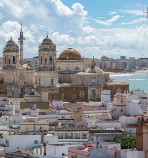 a view of a city with buildings and the ocean