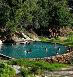 a group of people swimming in a pool in a river