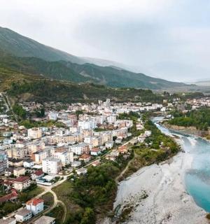 an aerial view of a town next to a river