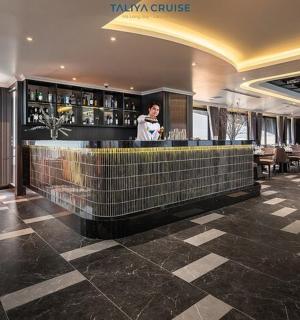 a woman standing at a bar in a restaurant