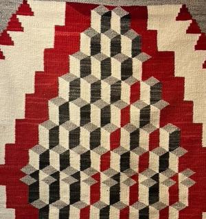 a close up of a quilt on a wall