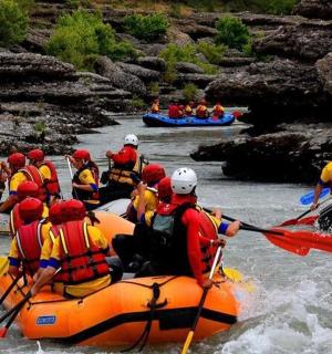 a group of people rafting down a river