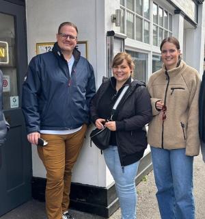 a group of people standing outside of a building