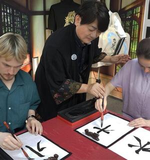 a group of people standing around a table with scissors