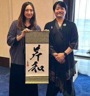 a man and a woman standing next to a sign
