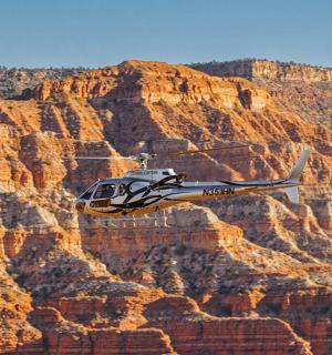 a helicopter flying over the grand canyon