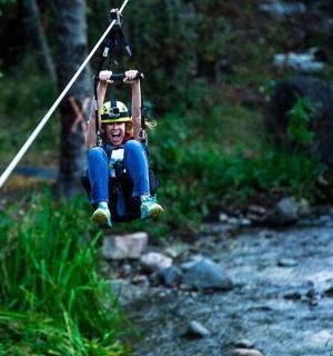 a person is swinging on a rope swing