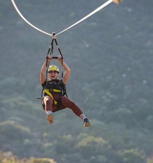 a person hanging from a rope on a parachute