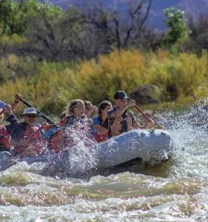 a group of people on a raft in a river