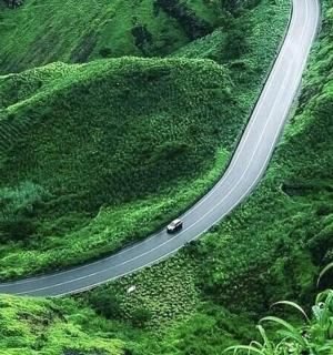 a car on a winding road in the mountains
